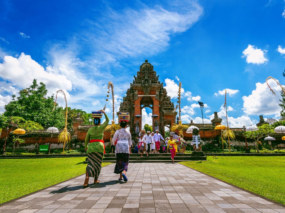 BALI, INDONESIA - APIRL 26, 2017 : Balinese people in traditional clothes during religious ceremony at Pura Taman Ayun Temple, Bali in Indonesia.